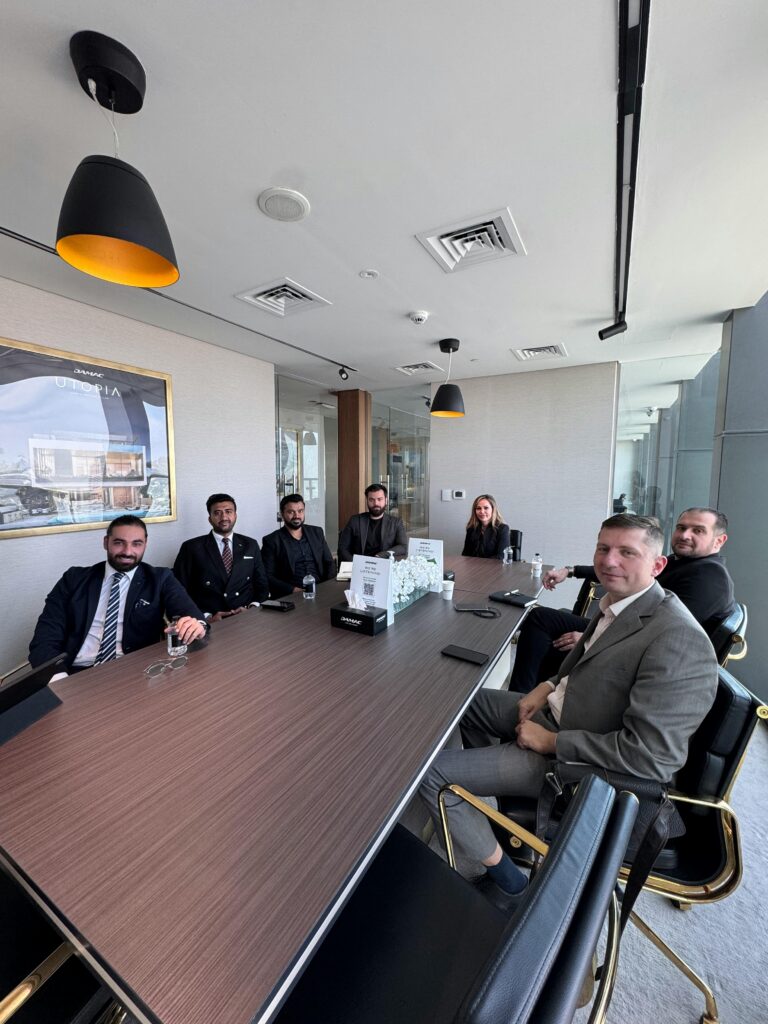 Business professionals in a formal meeting at a modern conference room.